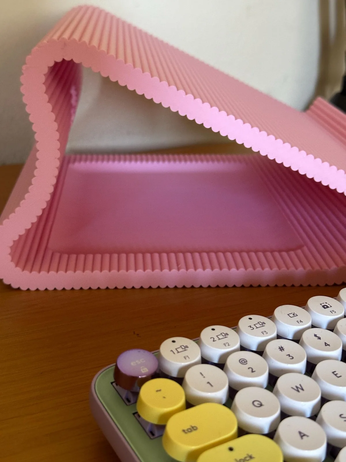 The storage area under the pink stand